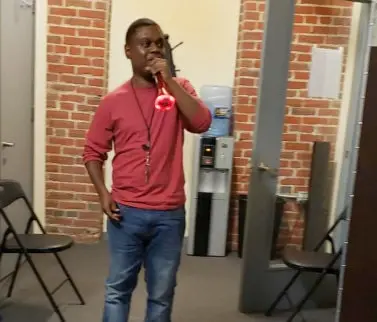 man on red shirt looking at distance